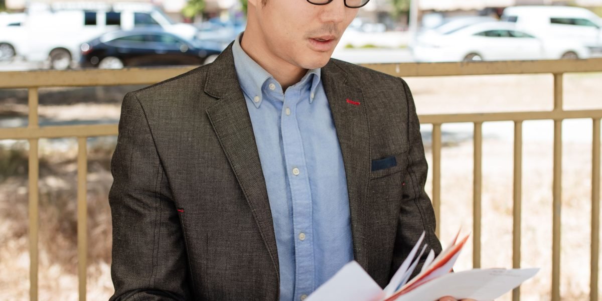 A policy professional carefully examining complex documents, reflecting the critical skill of deeply analyzing AI visuals and their implications.