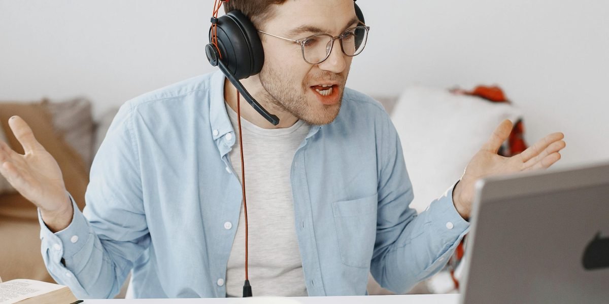 A person looking stressed during a virtual meeting, surrounded by visual cues of distracting background noise.