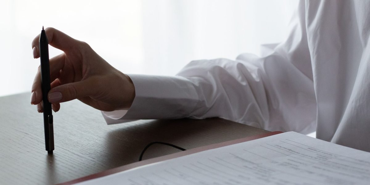 A professional meticulously reviewing documents, symbolizing the stringent compliance checks required in sensitive environments.