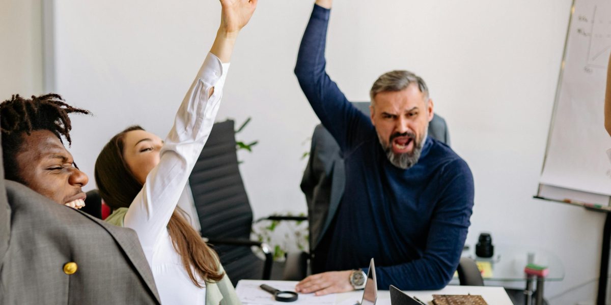 A diverse business team celebrating a successful project, reflecting market growth.