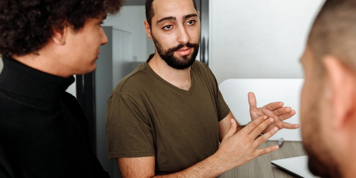 People engaging in a serious discussion about the profound implications of artificial intelligence on society.