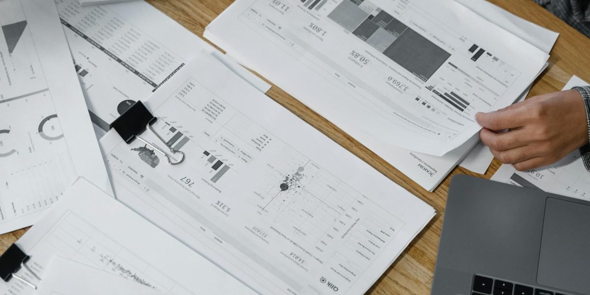 A business professional thoughtfully reviewing multiple documents, representing the challenge of navigating diverse state and international privacy laws.