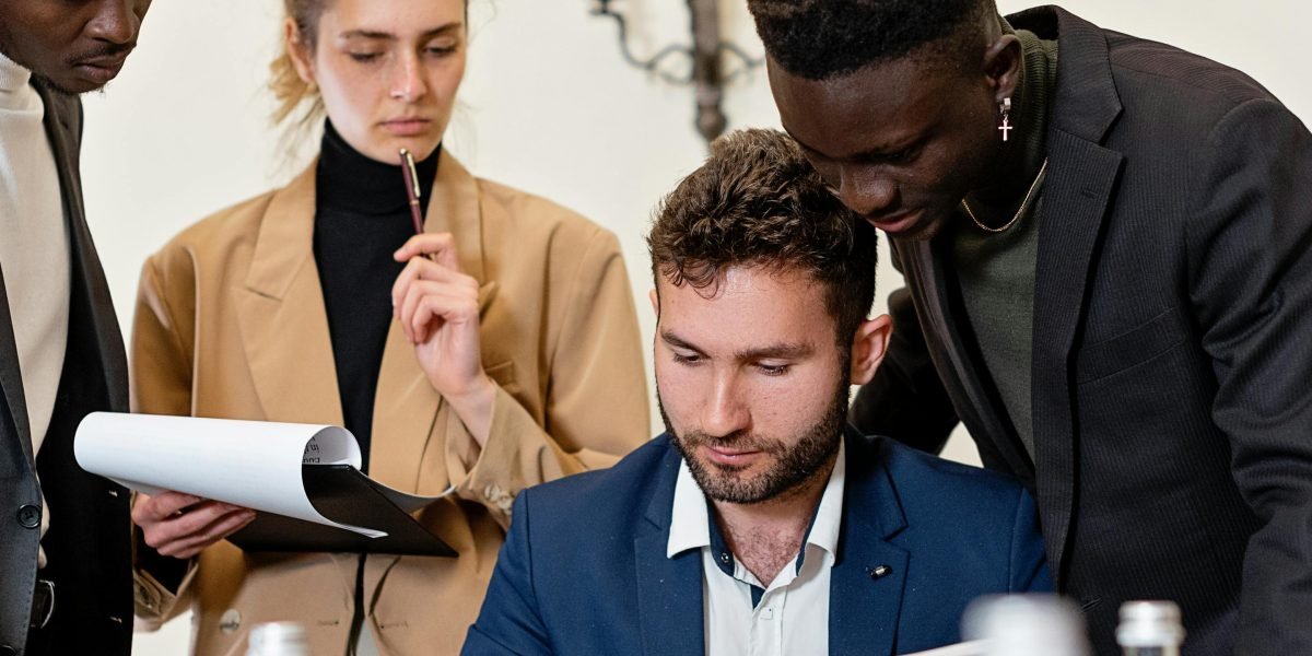 A diverse group collaborating, illustrating an AI review board or team discussing ethical implementation.