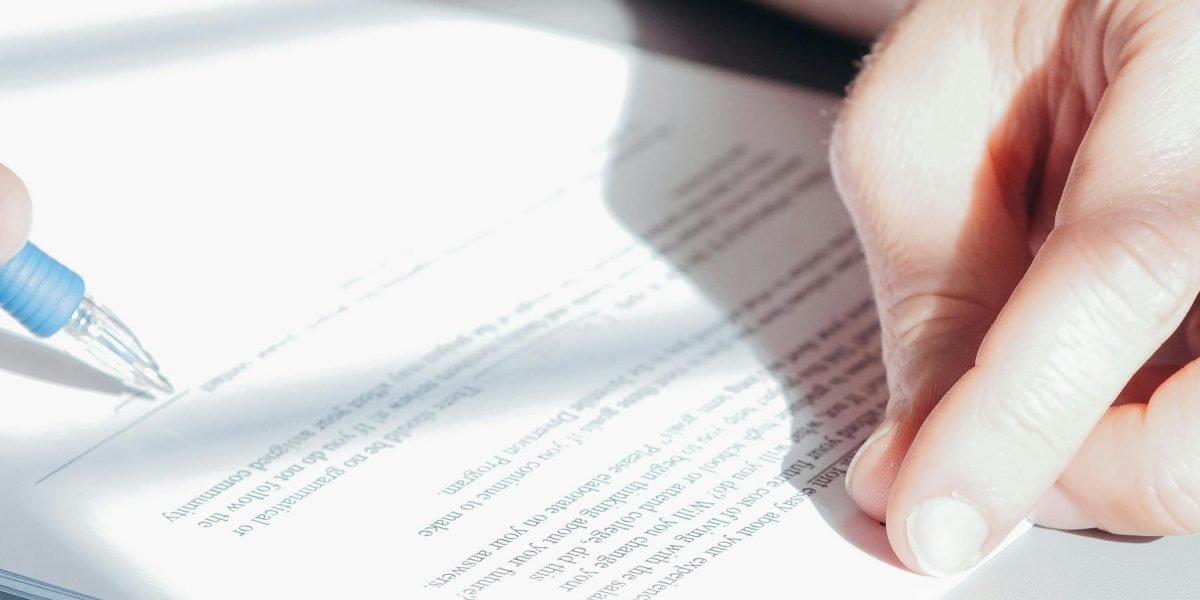 A professional thoughtfully reviewing legal documents, representing the careful consideration of AI policy and ethics.