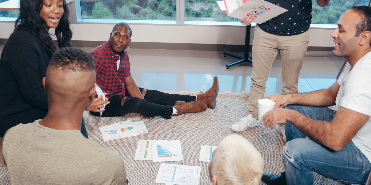 Professionals engaging in a focused discussion about AI strategy and its implications for business and policy.