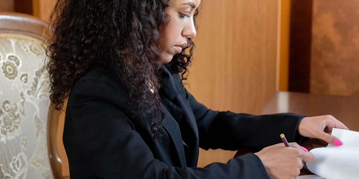 A professional intently reviewing various documents, symbolizing the complexity of navigating data privacy policies.