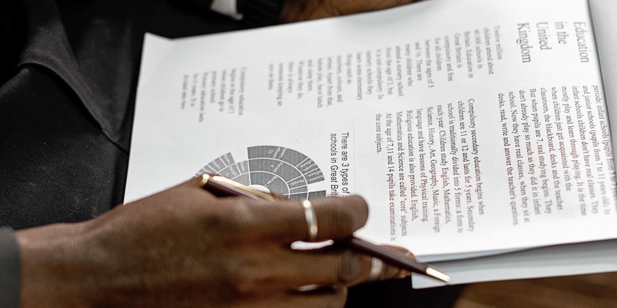 A policy professional carefully reviews confidential documents, reflecting the sensitive nature of their work.