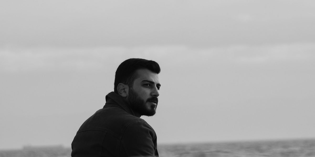 A person looks thoughtful and concerned, reflecting the widespread anxiety felt by professionals amidst tech layoffs and economic uncertainty.