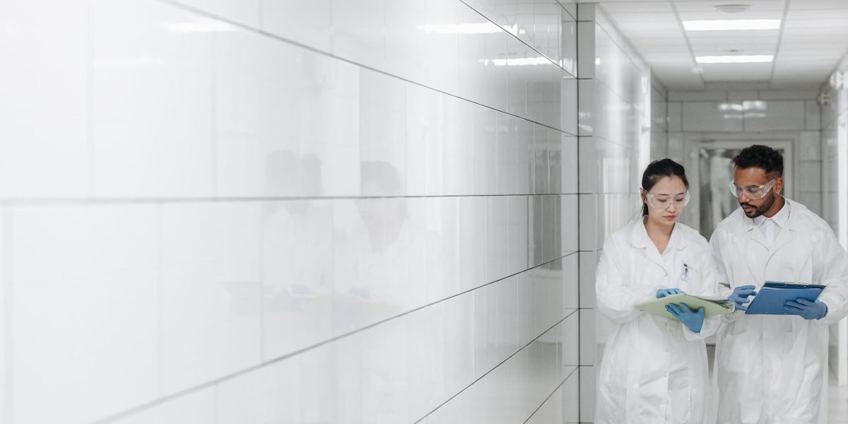Scientists collaborate in a modern lab, leveraging advanced AI to accelerate research and discovery.