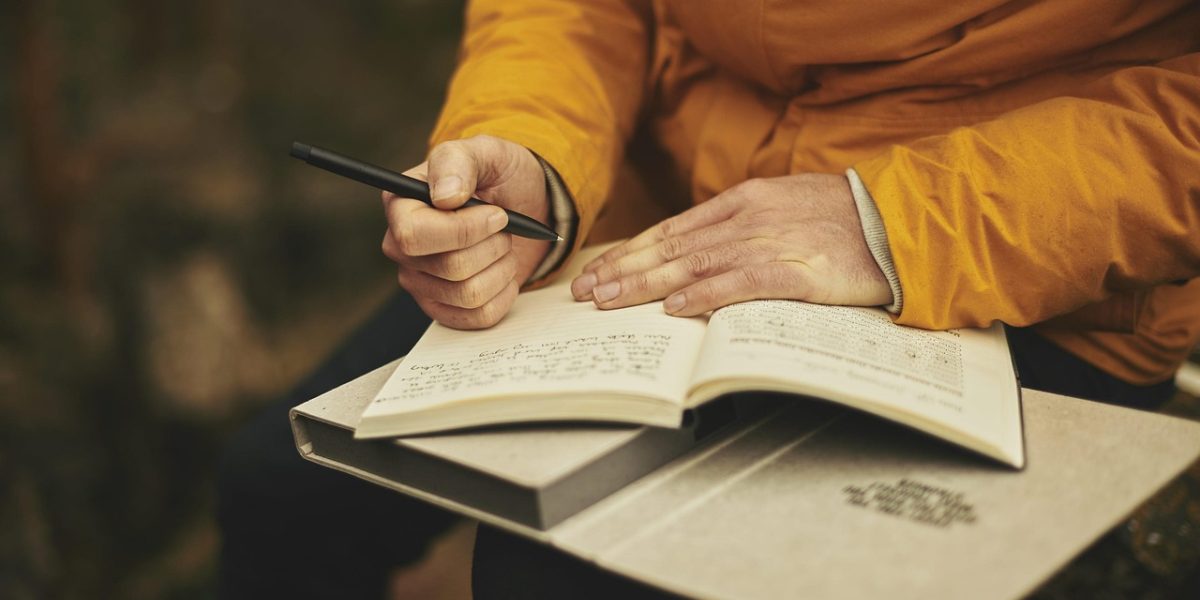 A person focused on reading, representing the effort to stay informed amidst the overwhelming amount of regulatory information.