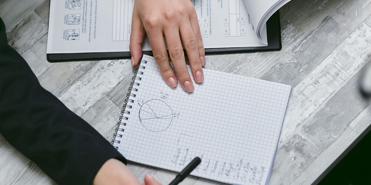 A business professional meticulously analyzing various documents, representing the challenge of navigating diverse AI regulations.