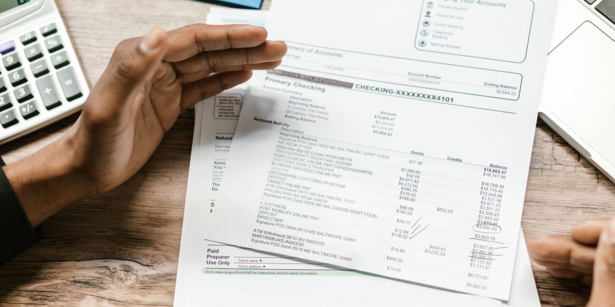 Business leaders reviewing financial documents, symbolizing the strategic and economic impacts of AI policies on investment and resource allocation.