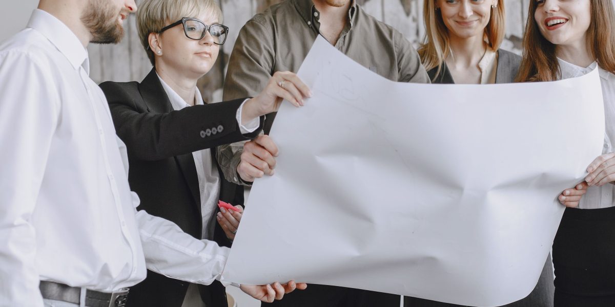 A diverse team collaborates in a meeting, actively engaged in strategic planning to develop robust policies, emphasizing collaboration and foresight.