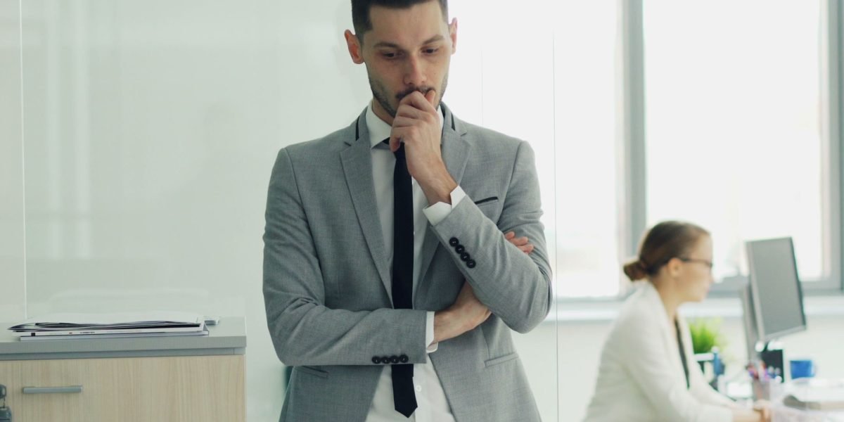An individual deeply contemplating crucial initial business structure decisions.