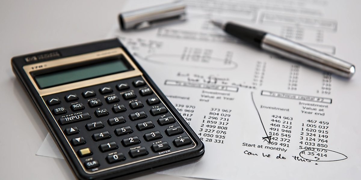 A business owner diligently reviews financial documents, planning for strategic funding and sustainable growth.