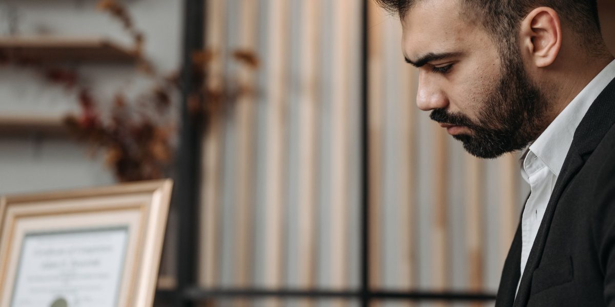 An expert carefully scrutinizing financial documents as part of a due diligence process to uncover hidden details.