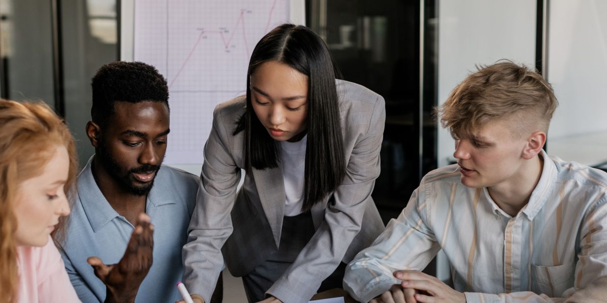 A diverse team collaborates on strategic initiatives, symbolizing strong enterprise-education partnerships.