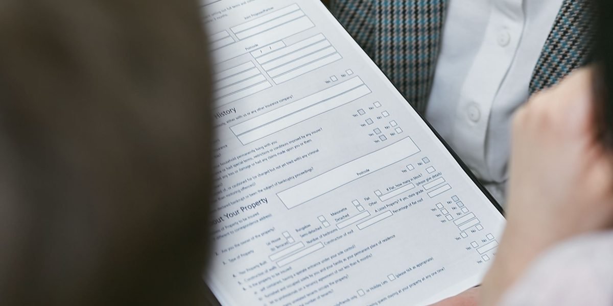 Policy experts intently reviewing legal documents and reports, illustrating the detailed work involved in connecting definitions to regulation.