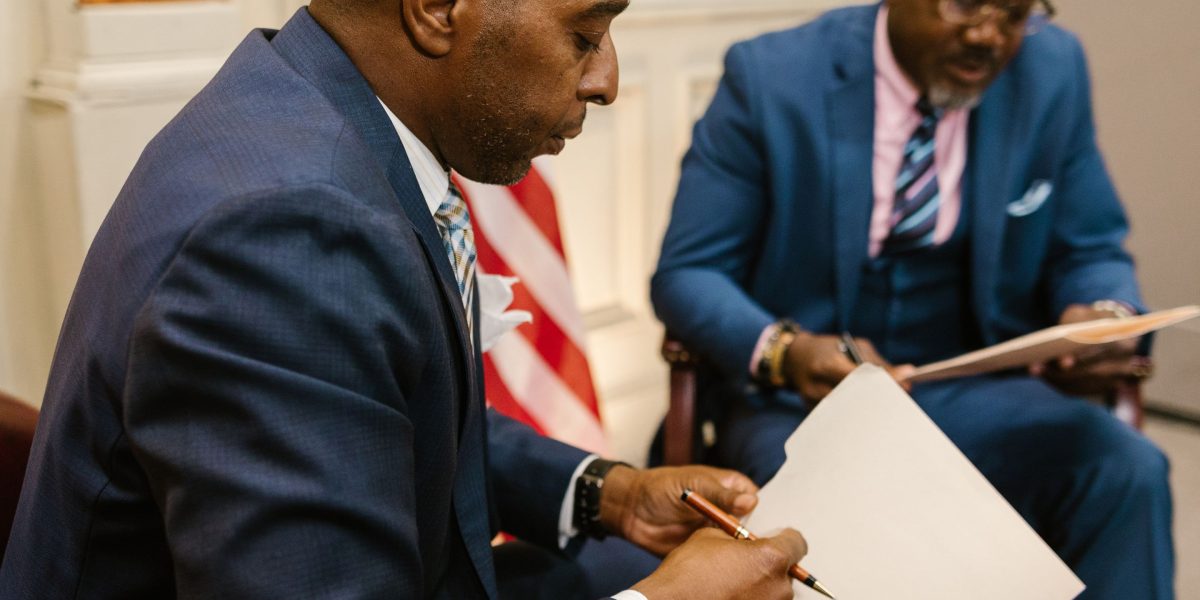 Government officials review documents, focusing on establishing AI standards for public benefit.