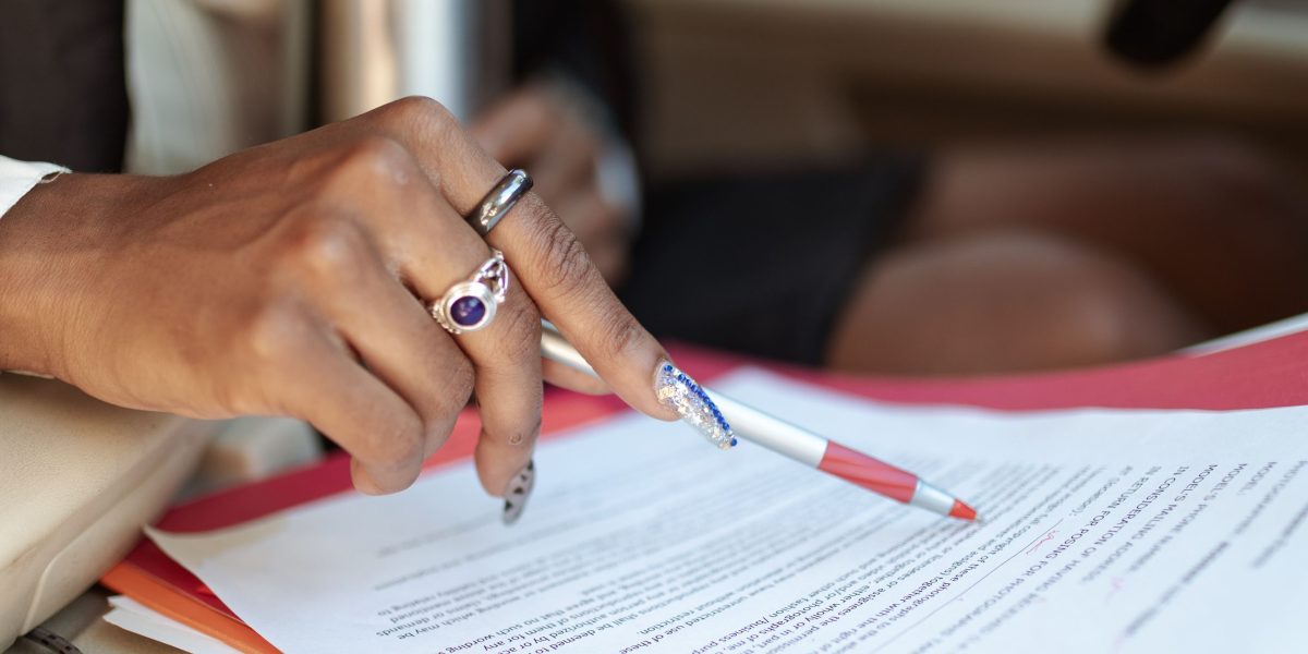 An expert meticulously reviewing detailed legal or policy documents, highlighting the depth of study required for AI governance.