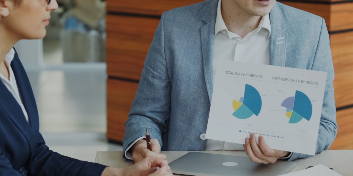 A confident professional presenting a report to colleagues, representing the crucial role of transparent reporting and independent audits in building trust in AI.