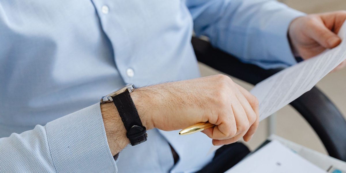 A person reviewing documents, symbolizing the challenge of understanding fast-changing regulations.