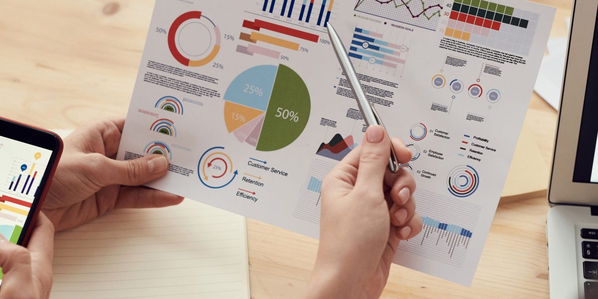 Teams collaboratively review economic data to understand regional performance and identify growth trends for new businesses.