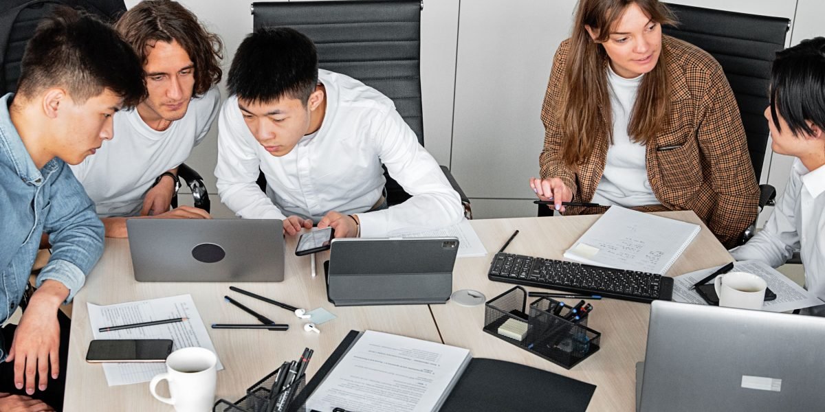 A team collaborates, analyzing market trends and potential strategies for their business.