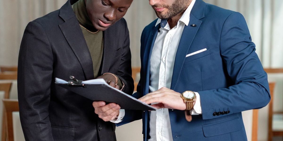 Professionals carefully reviewing legal documents and contracts, a critical step in vendor due diligence.