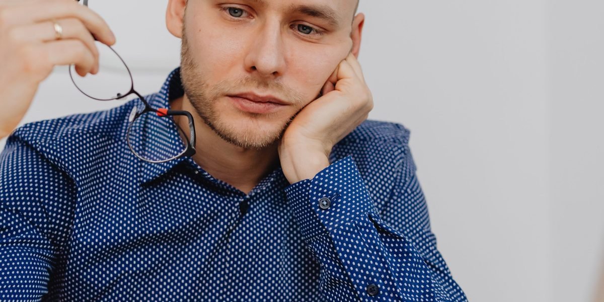 A person looking thoughtfully, symbolizing the careful consideration of ethical implications in AI design and policy.