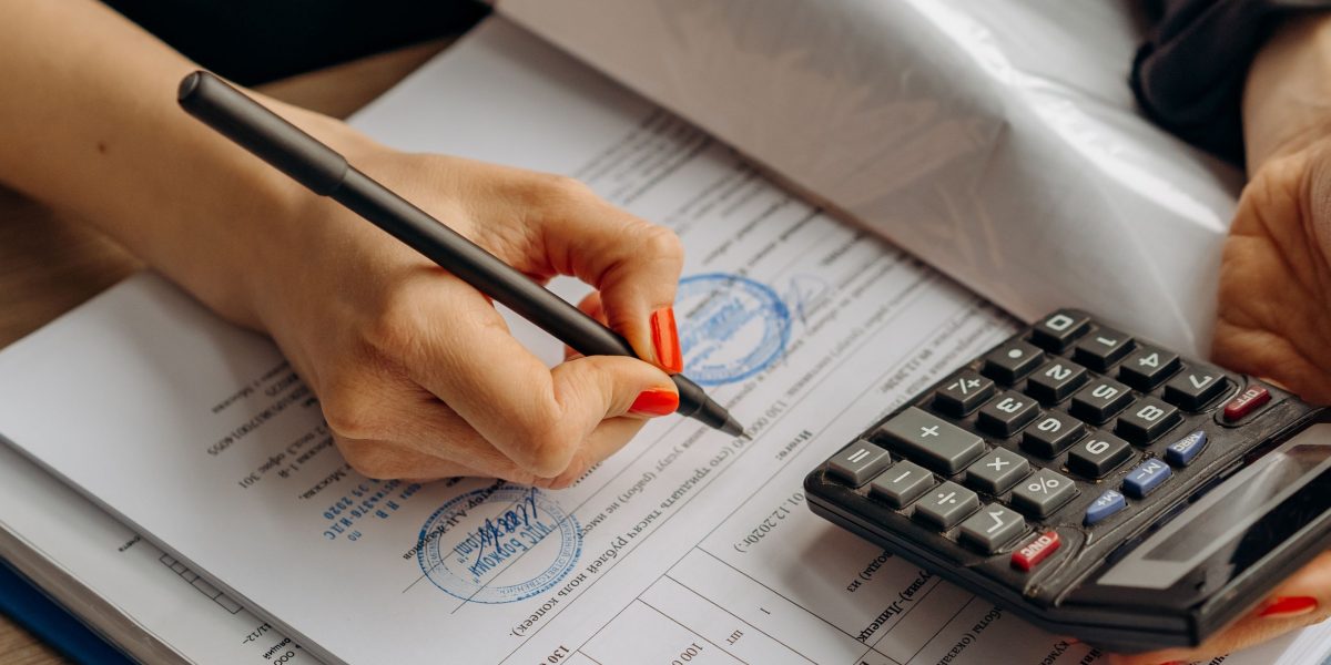 An auditor meticulously reviewing documents, representing the crucial process of evaluating and ensuring compliance for AI systems.