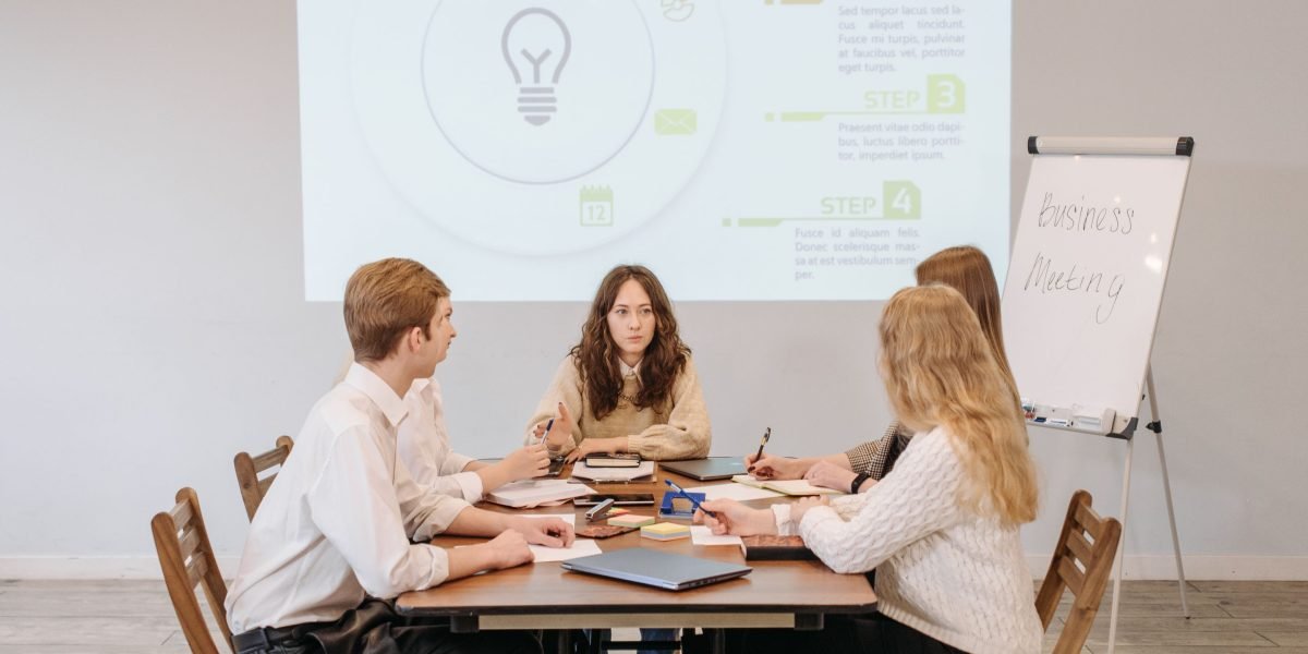A diverse team actively brainstorming ideas, possibly using a whiteboard or sticky notes, embodying the process of assessing market fit for new digital ventures.