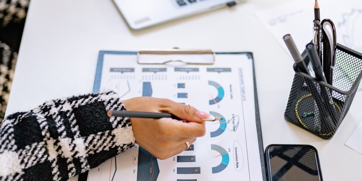 A person focused on a data dashboard, analyzing Key Performance Indicators to measure business growth and inform next steps.