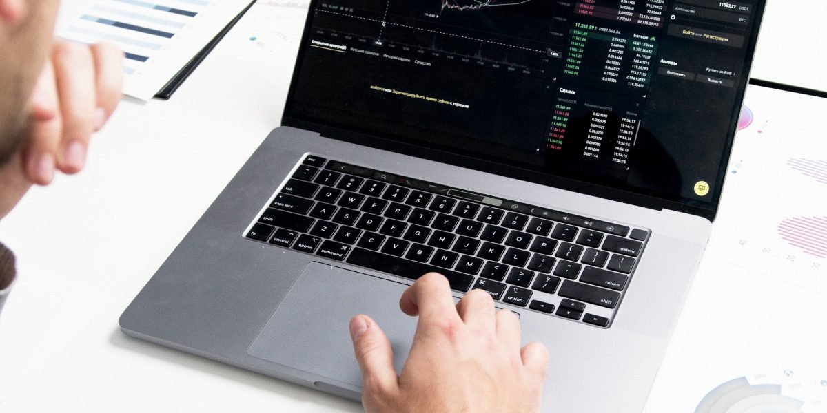 A business professional meticulously analyzing market data and trends to identify demand.