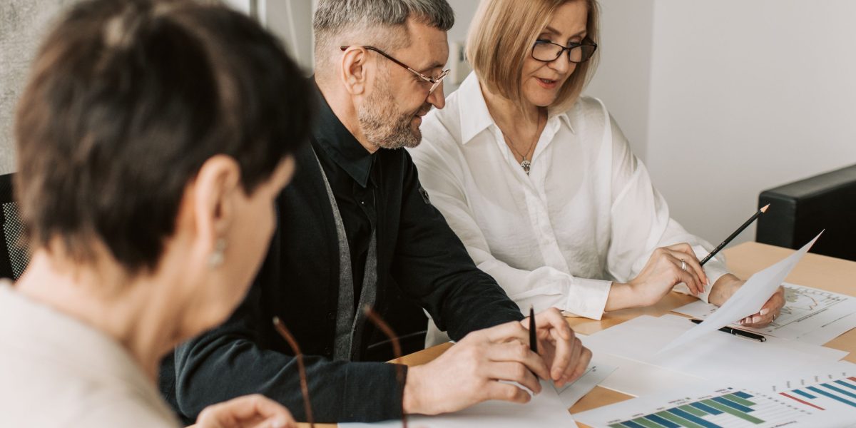 A diverse team working together, brainstorming and planning their organization's strategy for AI compliance and engagement in a rapidly changing environment.
